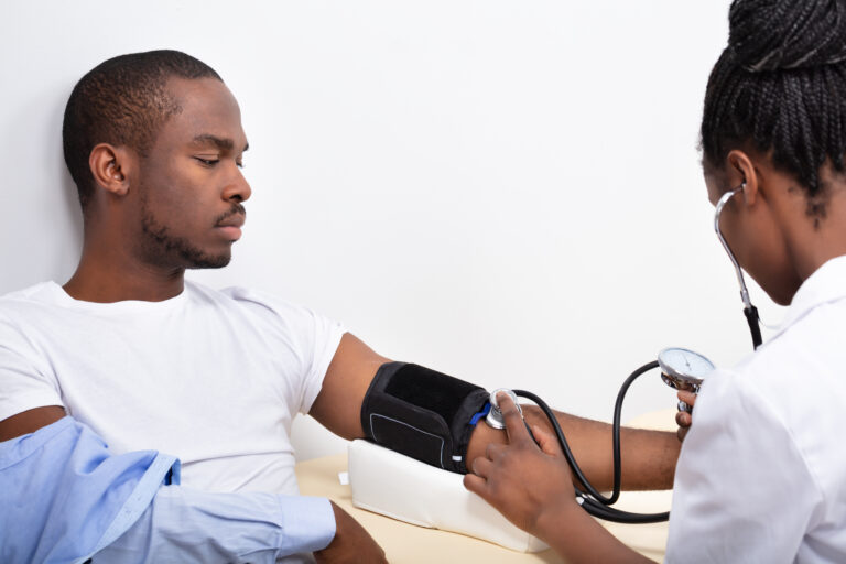 Close-up,Of,Doctor's,Hand,Measuring,Blood,Pressure,Of,Male,Patient